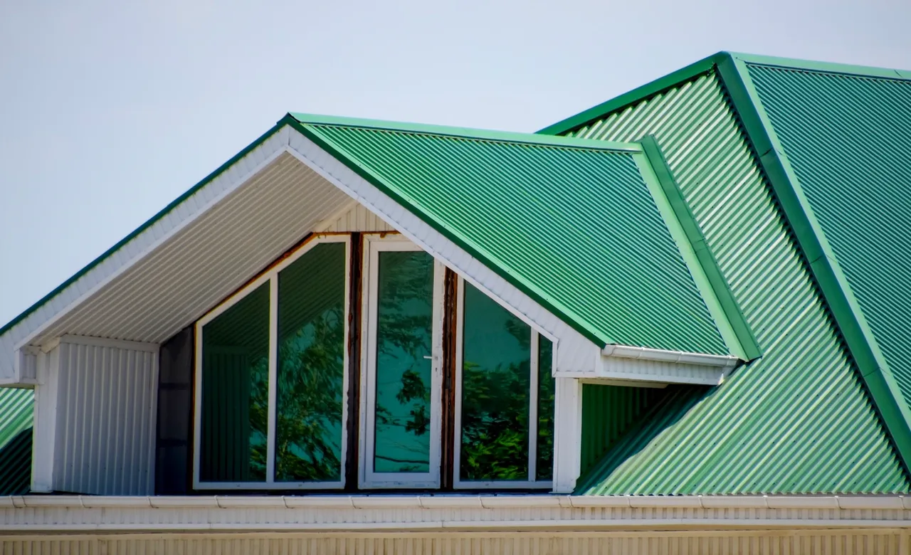 Green metal roof with dormer windows