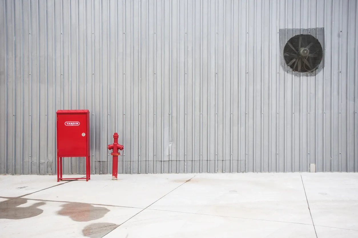 Fire safety equipment against metal wall