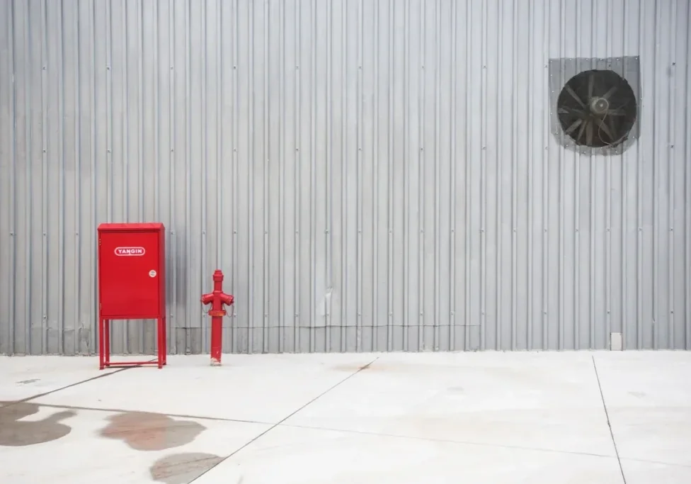 Fire safety equipment against metal wall